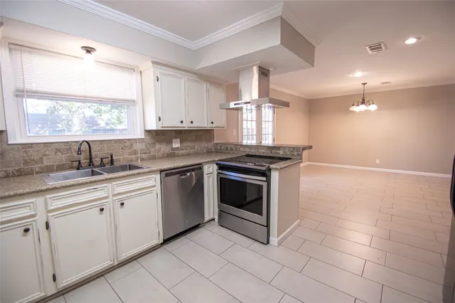 a kitchen with granite countertop white cabinets white appliances sink and window