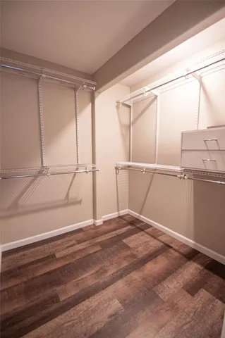 a view of a room with racks on the wall and a window