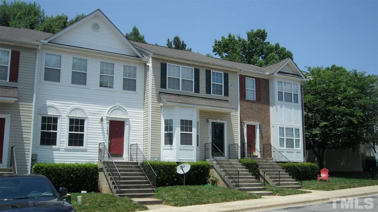 2830-102 Barrymore Street, Unit 102 Raleigh, NC 27603 - Photo 1 of 15 a front view of a house with a yard