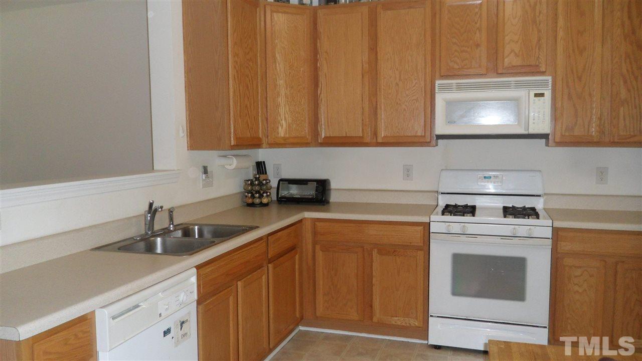 2830-102 Barrymore Street, Unit 102 Raleigh, NC 27603 - Photo 2 of 15 a kitchen with a sink cabinets and appliances