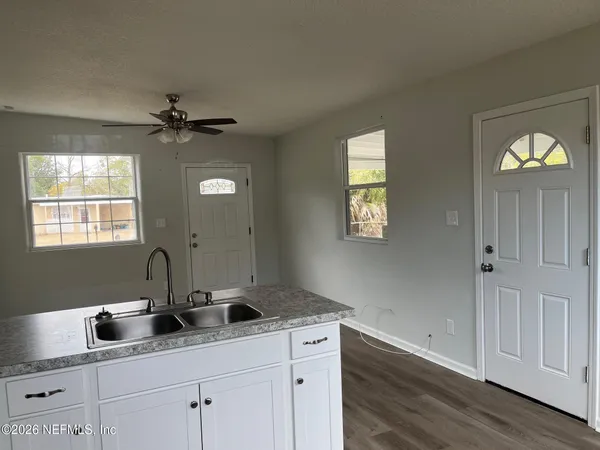 a view of a living room a window and a wooden floor