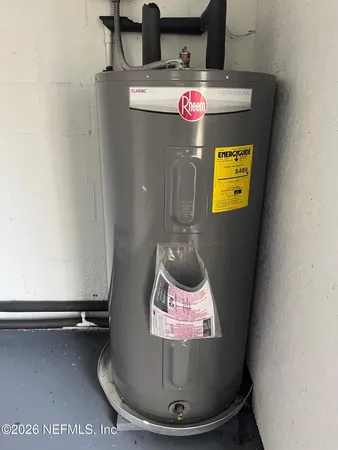 a view of a house with a yard and a large tree