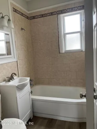a bathroom with a bathtub and a shower