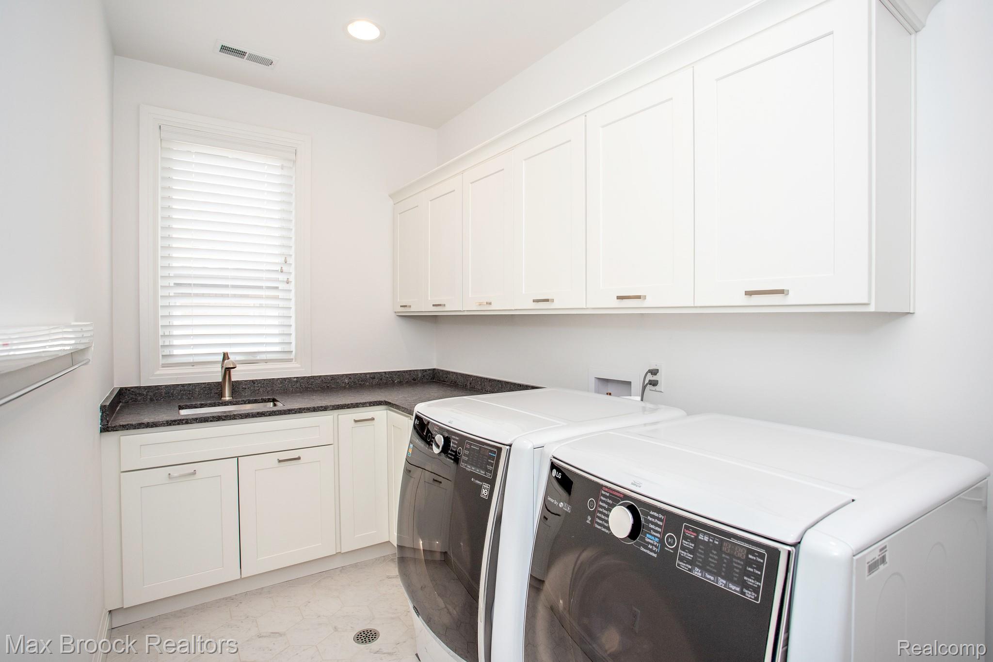 25925 York Road Royal Oak, MI 48067 - Photo 69 of 88 Laundry room with washing machine and clothes dryer, cabinet space, recessed lighting, and light marble finish floors