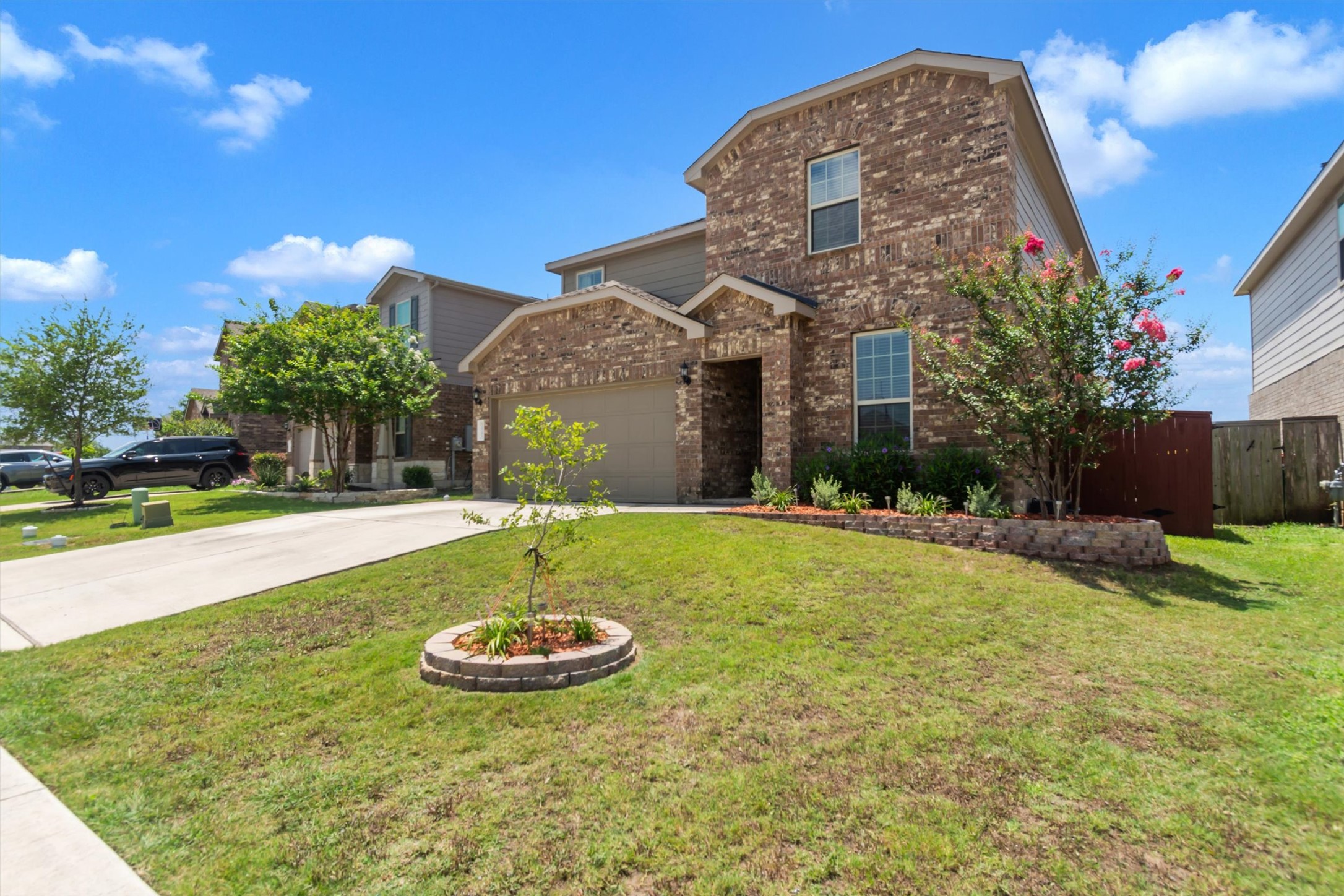 11701 Jackson Falls Way Manor, TX 78653 - Photo 2 of 40 A classic brick facade and neatly landscaped front yard create an inviting curb appeal.