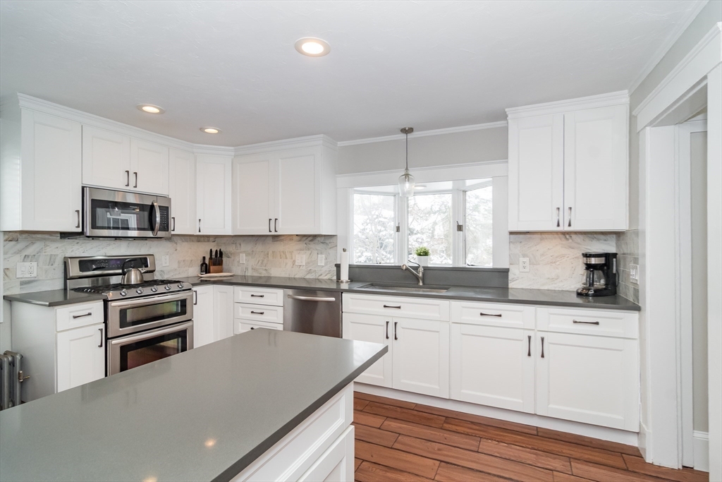 5 Hillcrest Road Framingham, MA 01702 - Photo 9 of 30 a kitchen with granite countertop white cabinets and white appliances