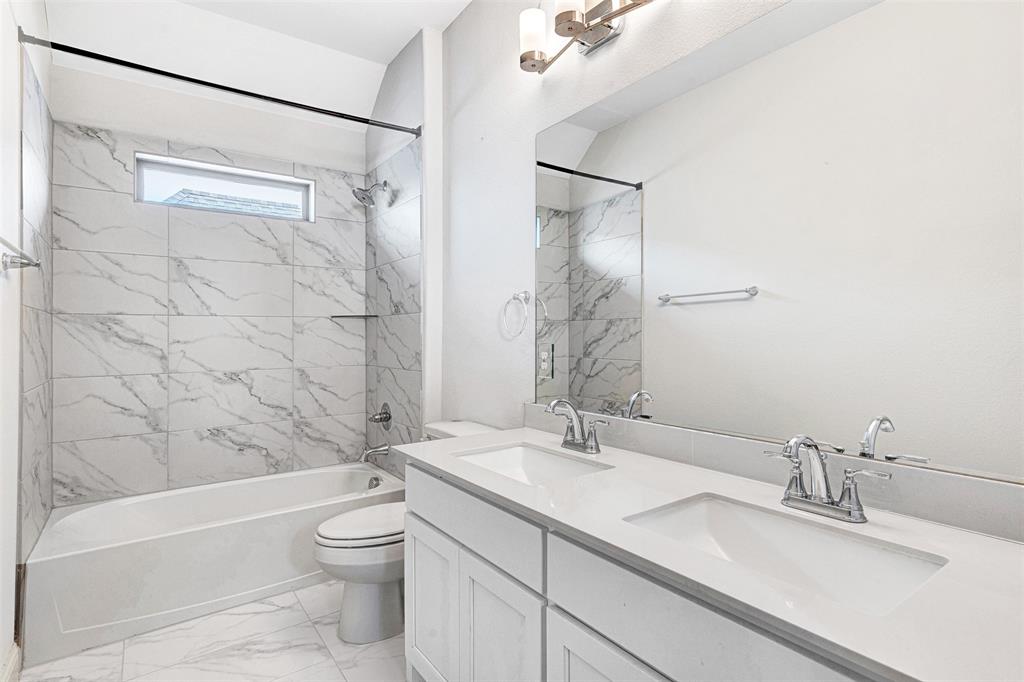 468 Caitlyn Way Fairview, TX 75069 - Photo 13 of 16 a bathroom with a granite countertop sink a toilet and shower