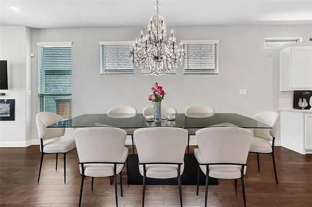 a view of a dining room with furniture wooden floor and chandelier