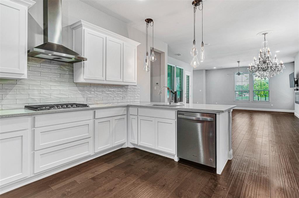 468 Caitlyn Way Fairview, TX 75069 - Photo 5 of 16 a kitchen with stainless steel appliances granite countertop a sink a stove a refrigerator and a wooden floor