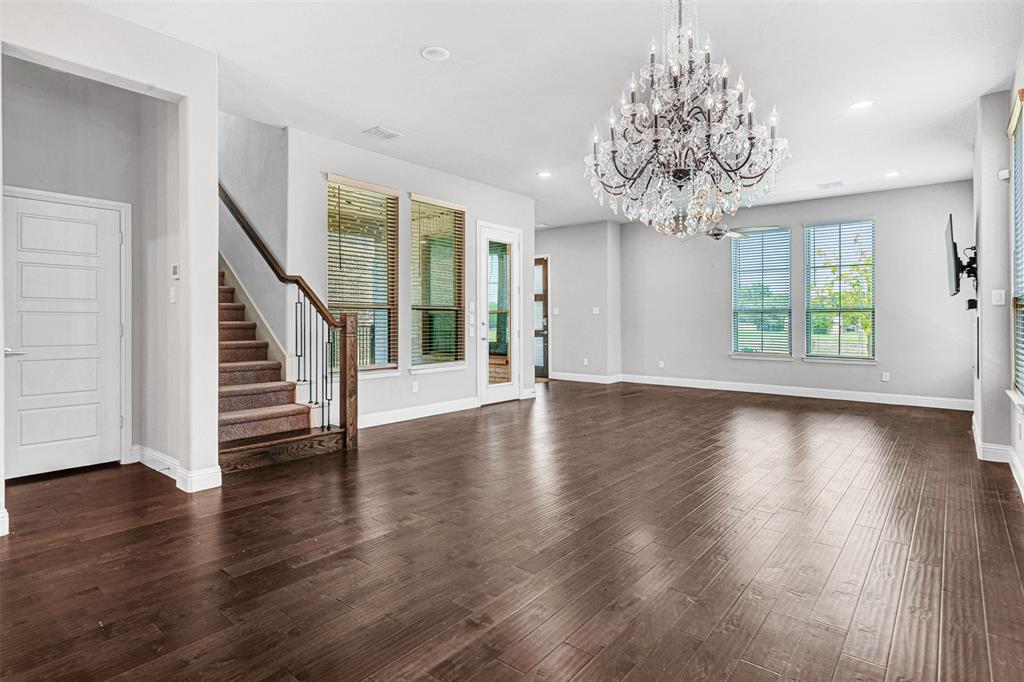 468 Caitlyn Way Fairview, TX 75069 - Photo 16 of 16 a view of a room with wooden floor chandelier and windows
