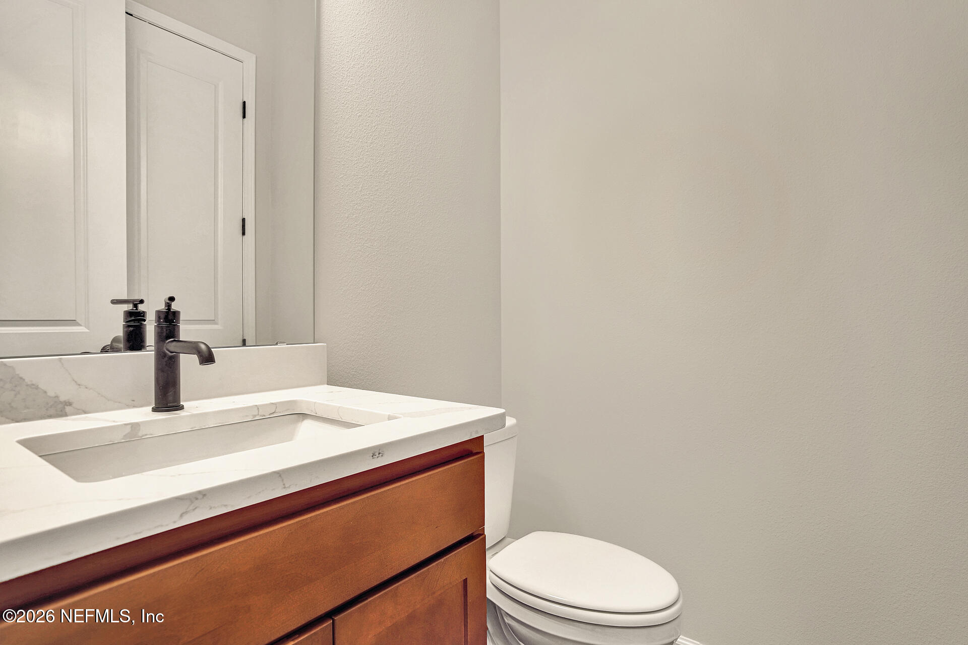 70 Ribera Drive, Unit 323 Flagler Beach, FL 32136 - Photo 6 of 16 a bathroom with a sink a toilet and mirror