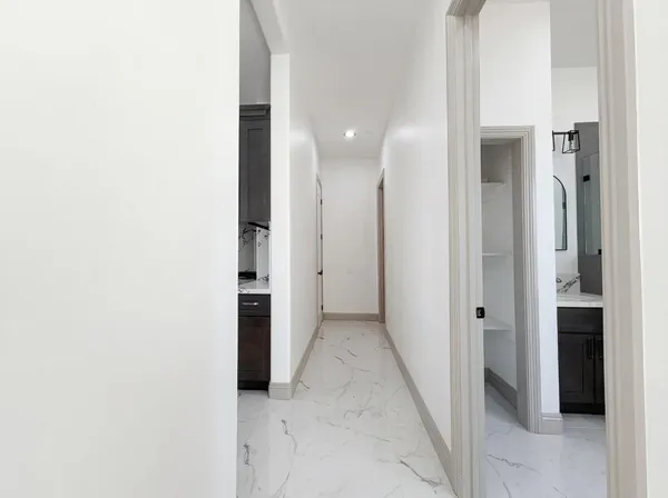 a bathroom with a mirror sink and glass door