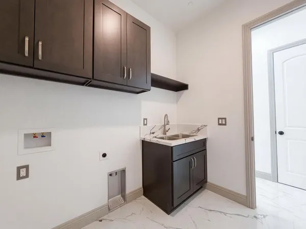 a kitchen with stainless steel appliances granite countertop a sink a stove and a refrigerator