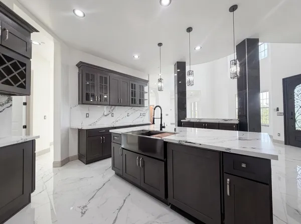 a large kitchen with stainless steel appliances a sink stove and refrigerator