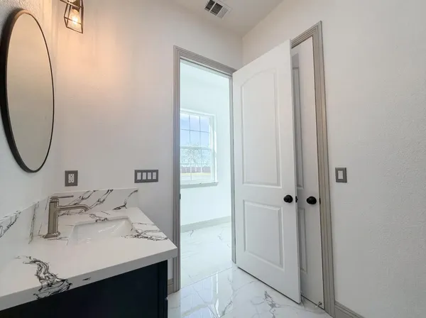 an empty room with a ceiling fan and window