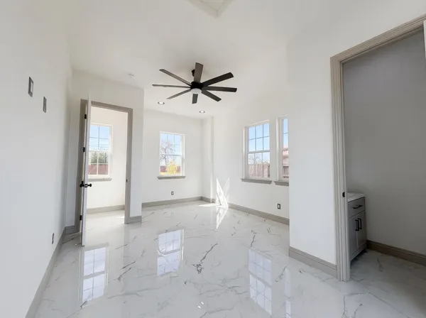 a view of a livingroom with a ceiling fan and window