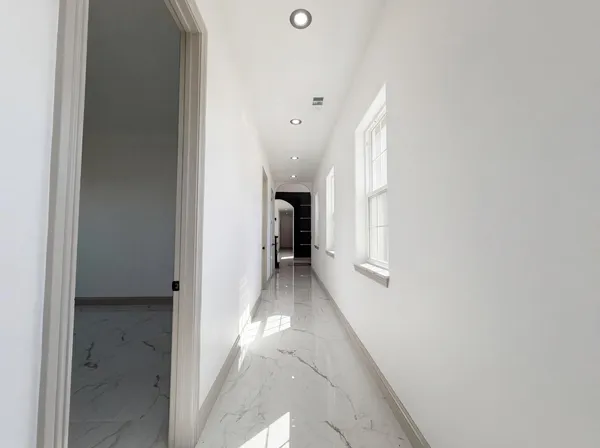 an empty room with a ceiling fan and a window