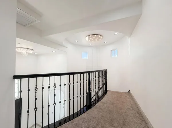 an empty room with a window and a ceiling fan