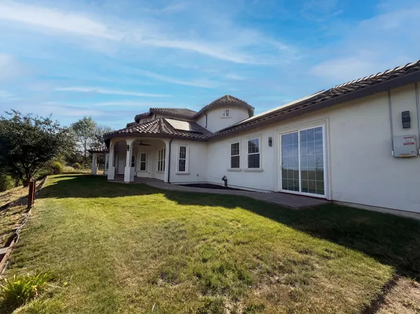 a view of a house with swimming pool and a yard