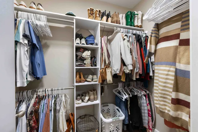 a bathroom with double vanity sink a two mirror a window and a mirror