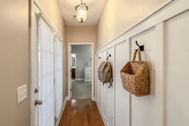 a spacious bedroom with a bed a couch and a chandelier