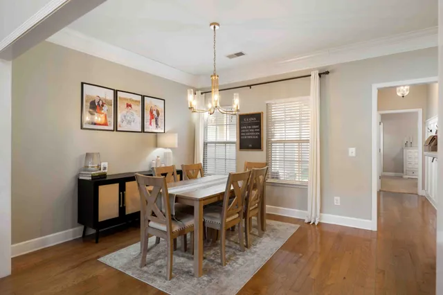 a bedroom with a bed and a flat tv screen on dresser