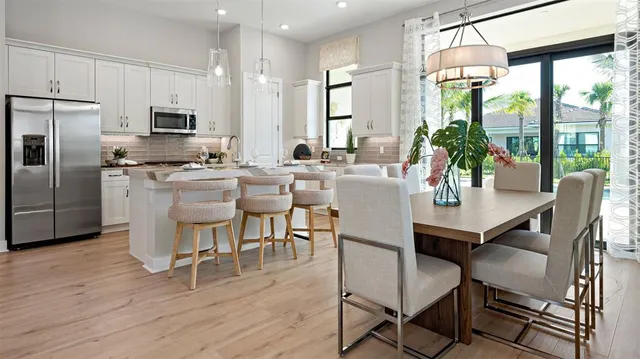 a dining room with furniture a large window and wooden floor