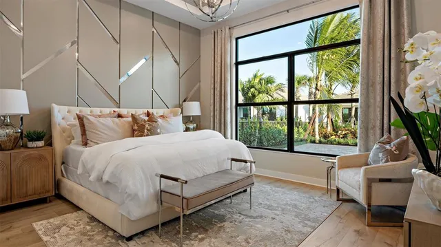 a bedroom with a bed and a large window