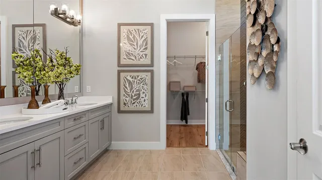 a spacious bathroom with a double vanity sink and a mirror