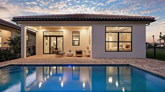 a bathroom with a granite countertop sink a mirror and bathtub