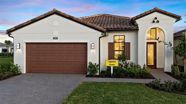 a front view of house with a garden