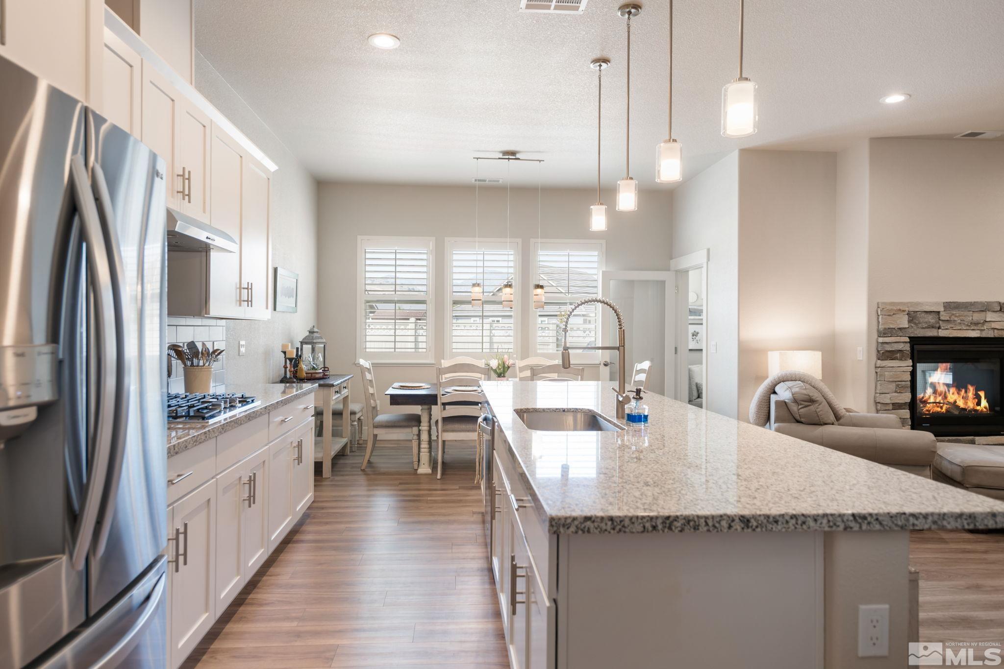 233 Cecina Drive Dayton, NV 89403 - Photo 17 of 39 a kitchen with stainless steel appliances granite countertop a sink a stove and a refrigerator