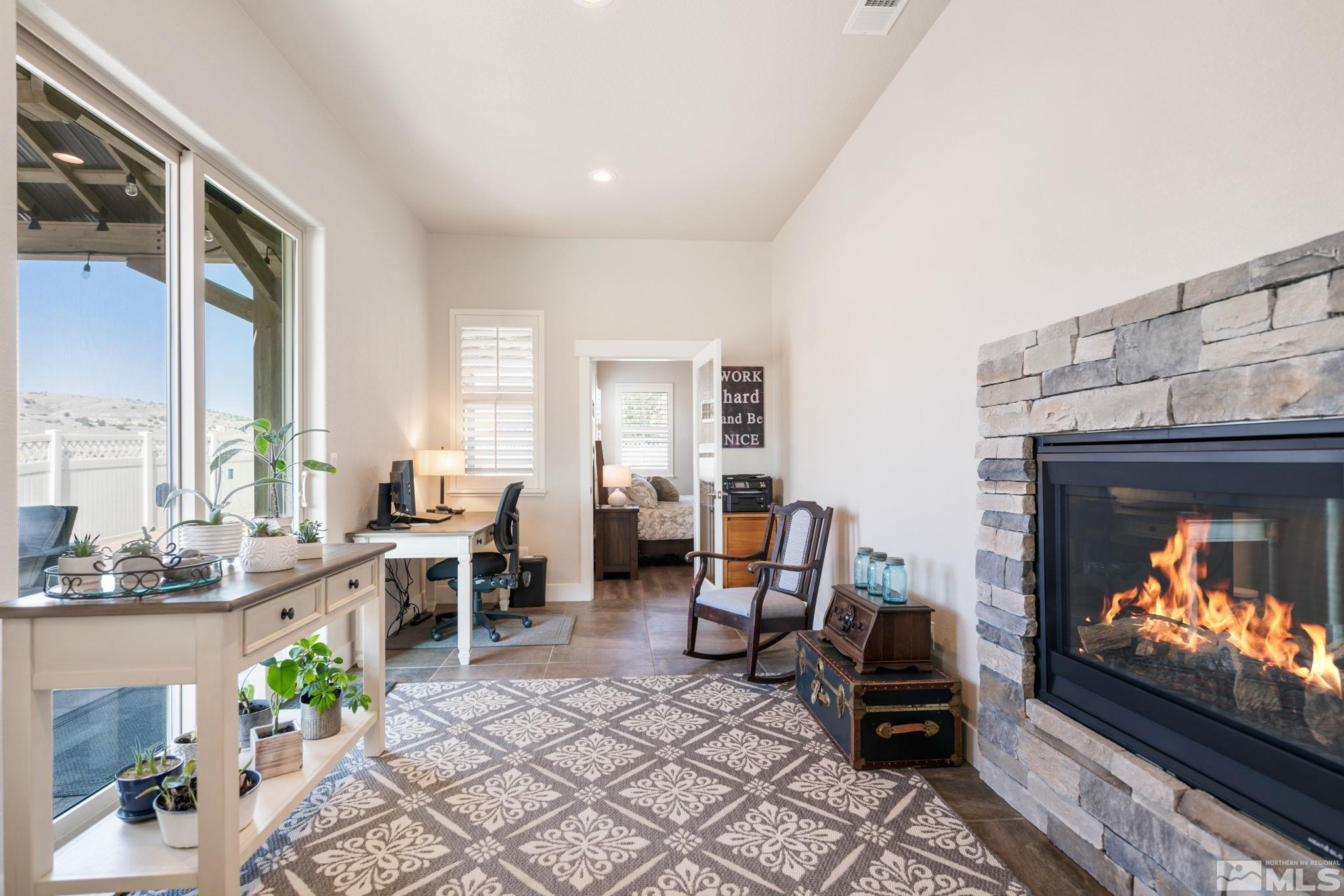 233 Cecina Drive Dayton, NV 89403 - Photo 22 of 39 a living room with furniture a fireplace and a floor to ceiling window