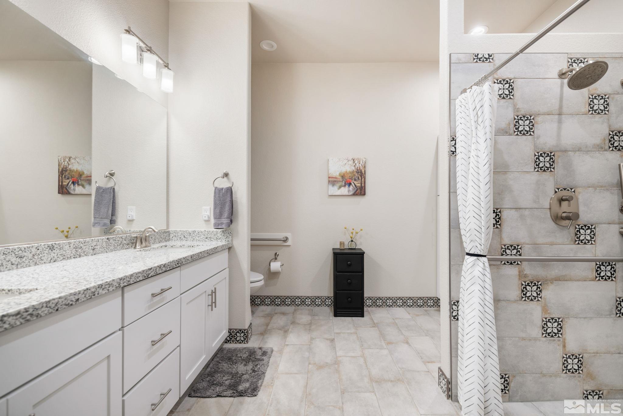 233 Cecina Drive Dayton, NV 89403 - Photo 24 of 39 a spacious bathroom with a granite countertop sink a mirror and shower