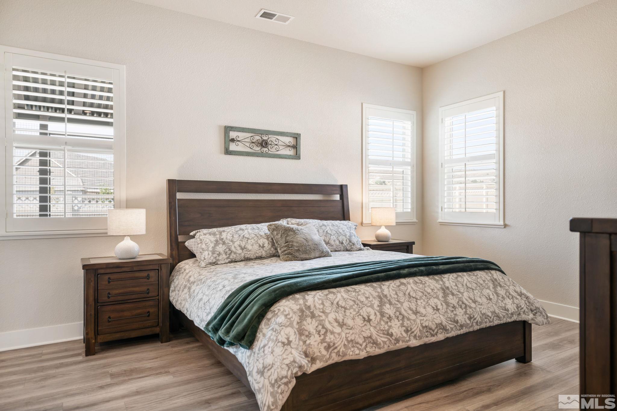 233 Cecina Drive Dayton, NV 89403 - Photo 26 of 39 a bedroom with a bed a closet and a window