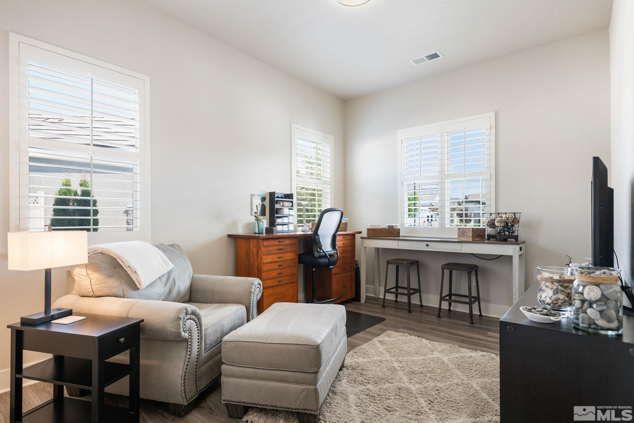 233 Cecina Drive Dayton, NV 89403 - Photo 29 of 39 a living room with furniture a fireplace and a table