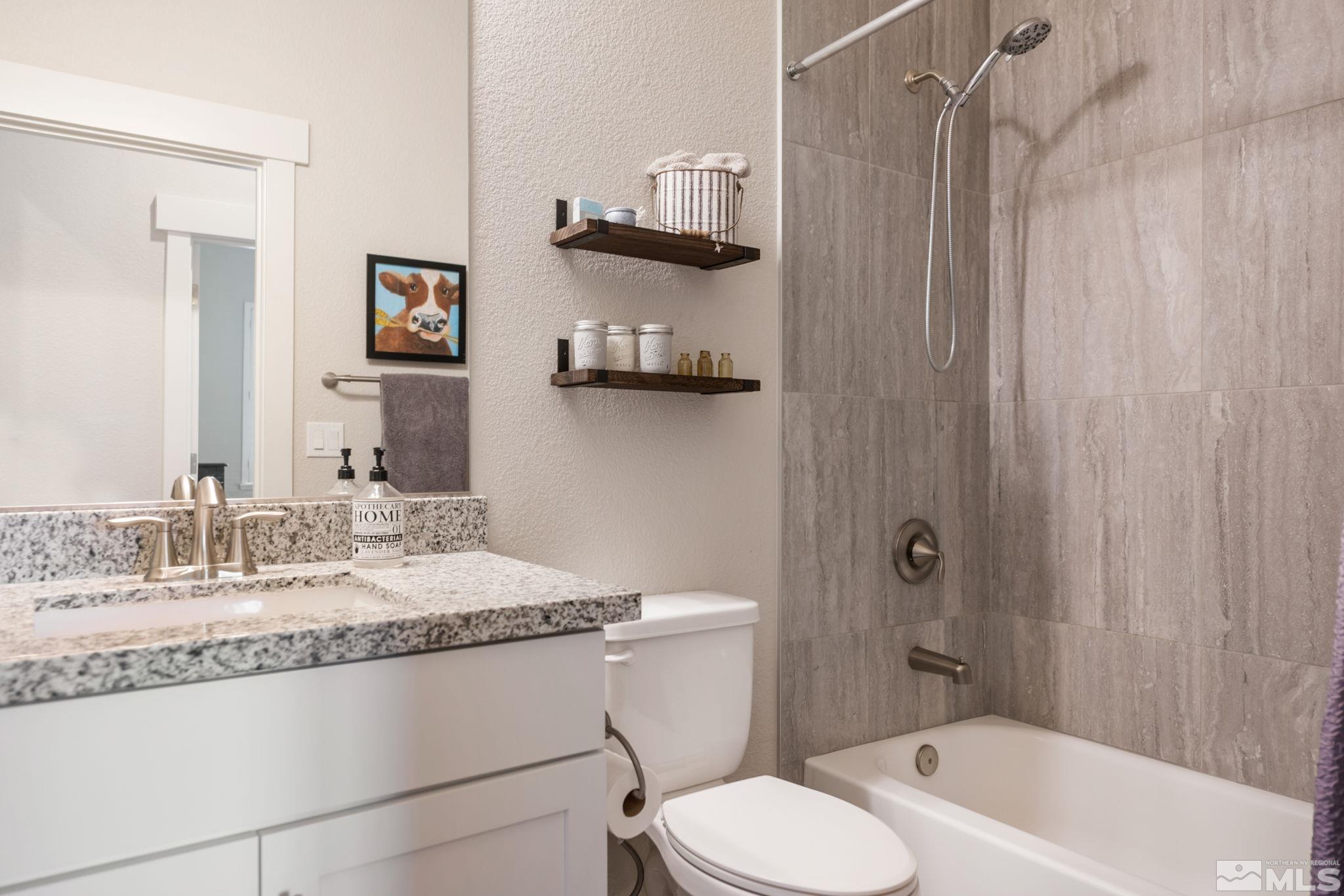 233 Cecina Drive Dayton, NV 89403 - Photo 31 of 39 a bathroom with a granite countertop sink toilet and shower