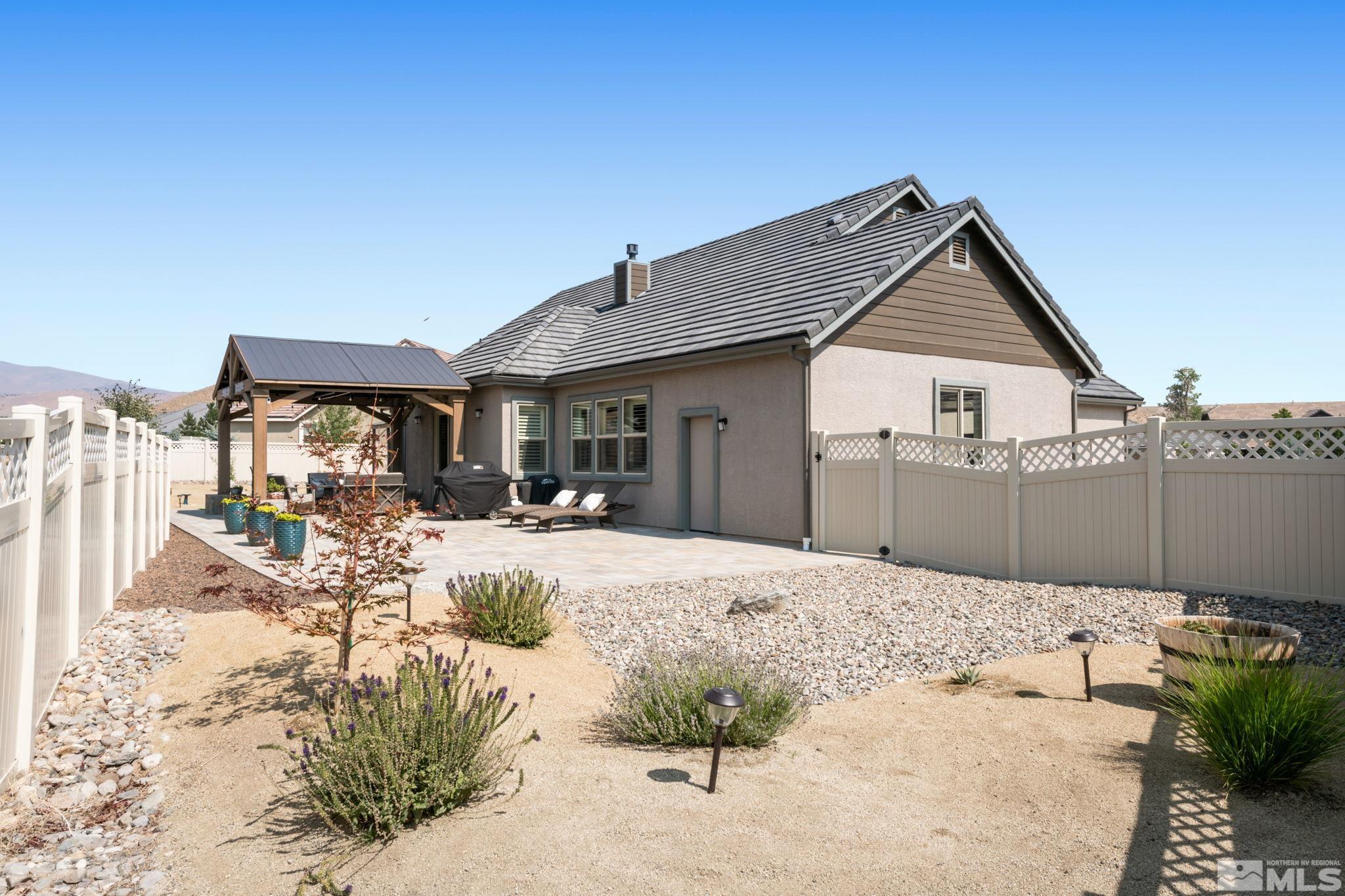 233 Cecina Drive Dayton, NV 89403 - Photo 36 of 39 a view of a house with backyard porch and sitting area