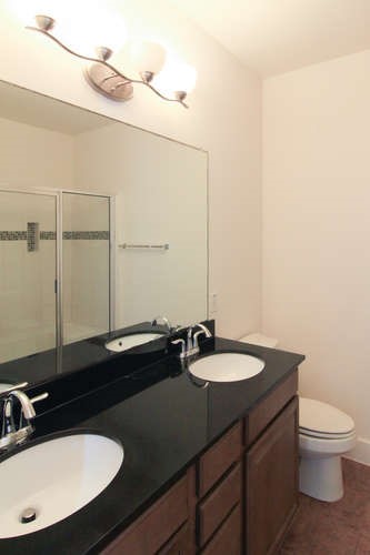 13420 Lyndhurst Street, Unit 401 408 303 Austin, TX 78717 - Photo 31 of 36 a bathroom with a sink and a mirror
