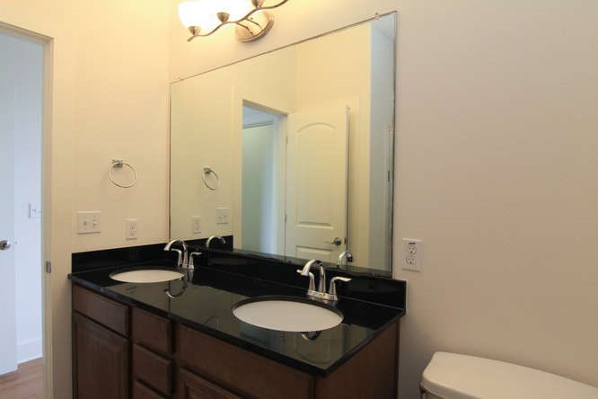 13420 Lyndhurst Street, Unit 401 408 303 Austin, TX 78717 - Photo 32 of 36 a bathroom with a granite countertop sink and a mirror