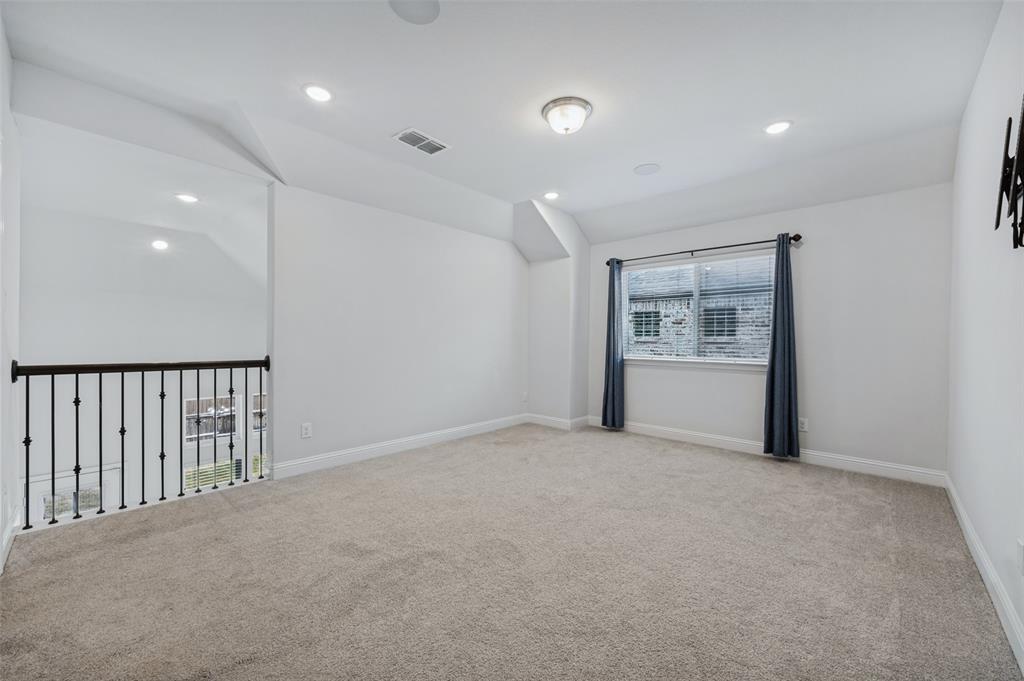 15862 Shasta Daisy Road Frisco, TX 75035 - Photo 10 of 15 Upstairs den/office/play/flex room featuring carpeted flooring, recessed lighting, ceiling-mounted light fixture, and wrought iron railing overlooking living room below.