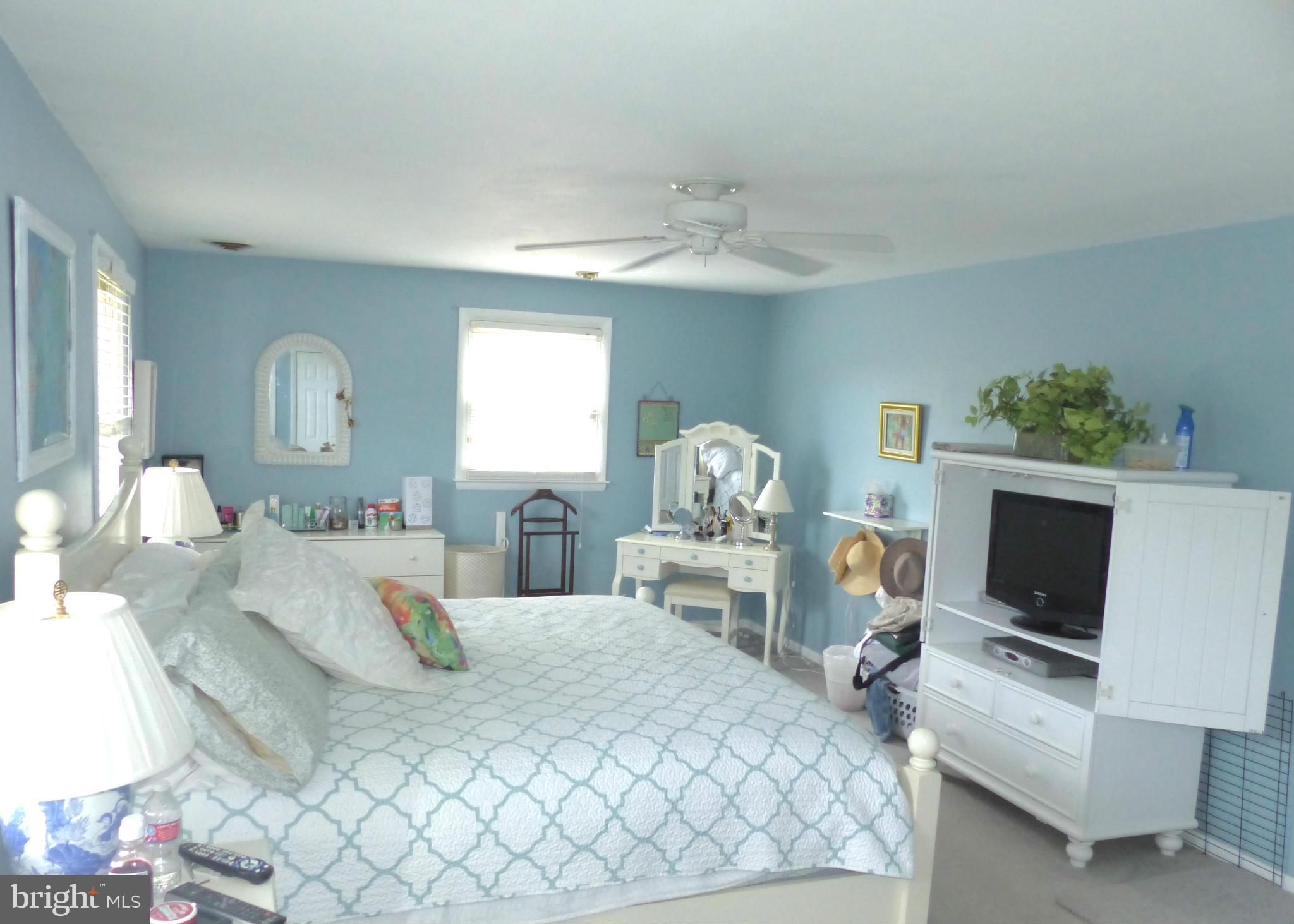 3004 Merrymans Mill Road Phoenix, MD 21131 - Photo 15 of 29 a bedroom with a bed a mirror on dresser and a flat screen tv