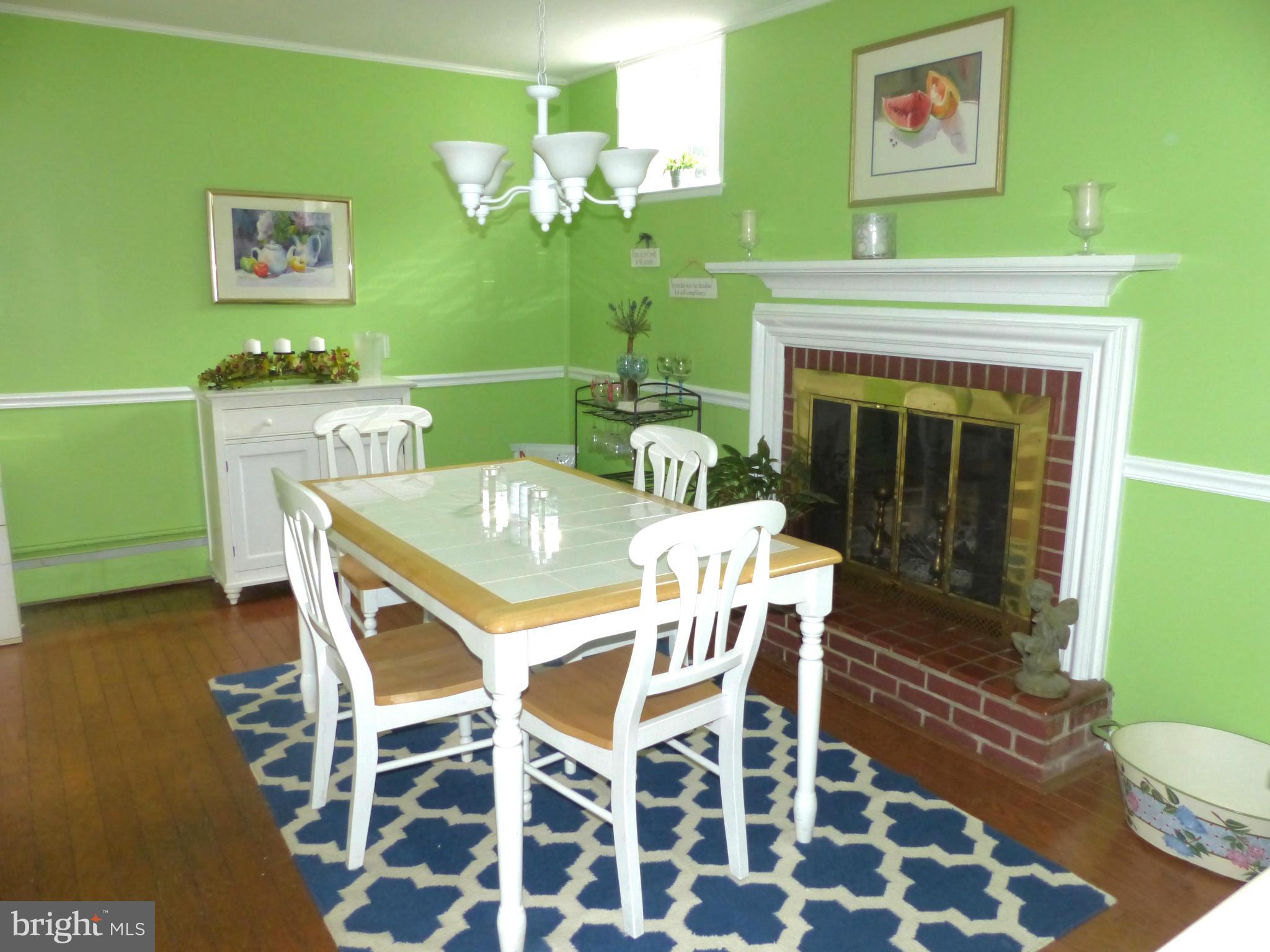 3004 Merrymans Mill Road Phoenix, MD 21131 - Photo 10 of 29 a dining room with furniture and a fireplace