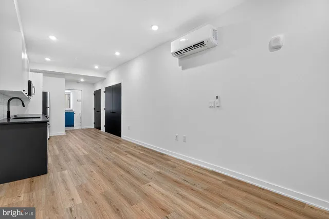 a view of a kitchen with a sink and a refrigerator