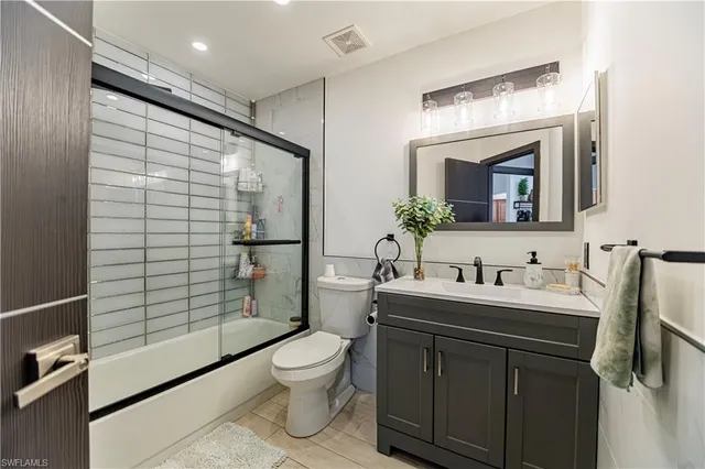 a bathroom with a toilet a sink and shower
