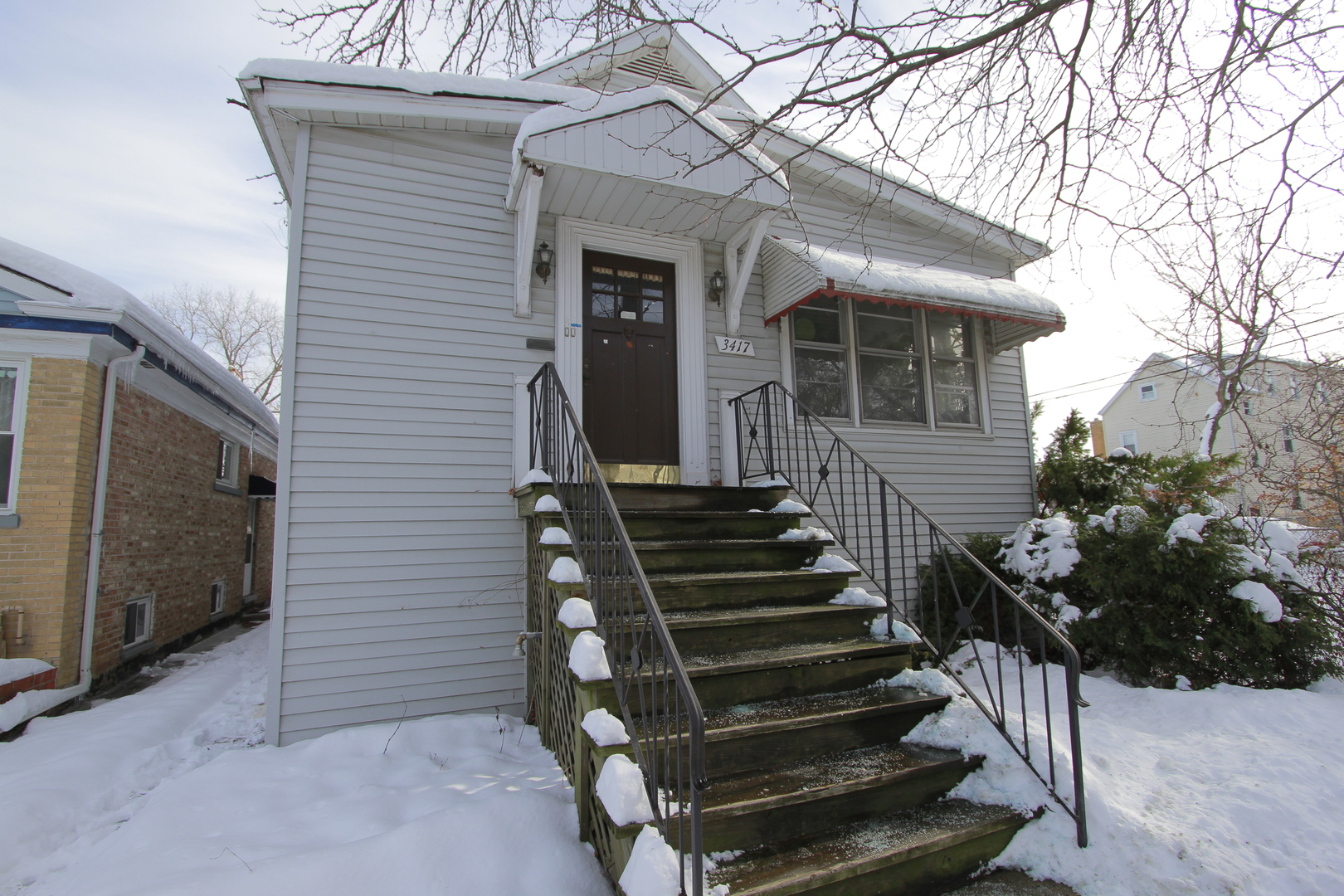 a view of a house with wooden fence and two windows