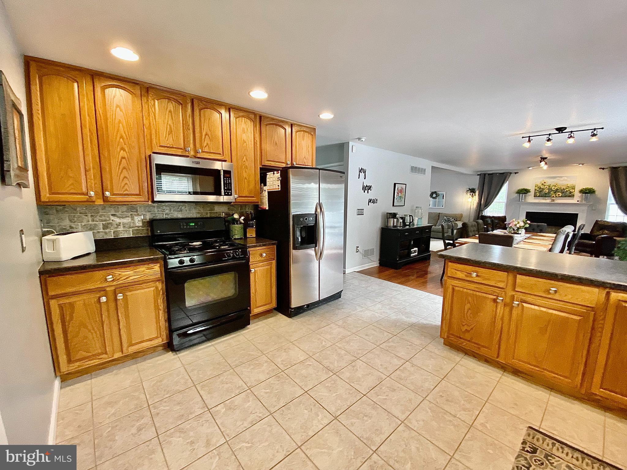 8 Augusta Street Wrightstown, NJ 08562 - Photo 11 of 44 a kitchen with stainless steel appliances granite countertop a refrigerator a stove top oven and a sink