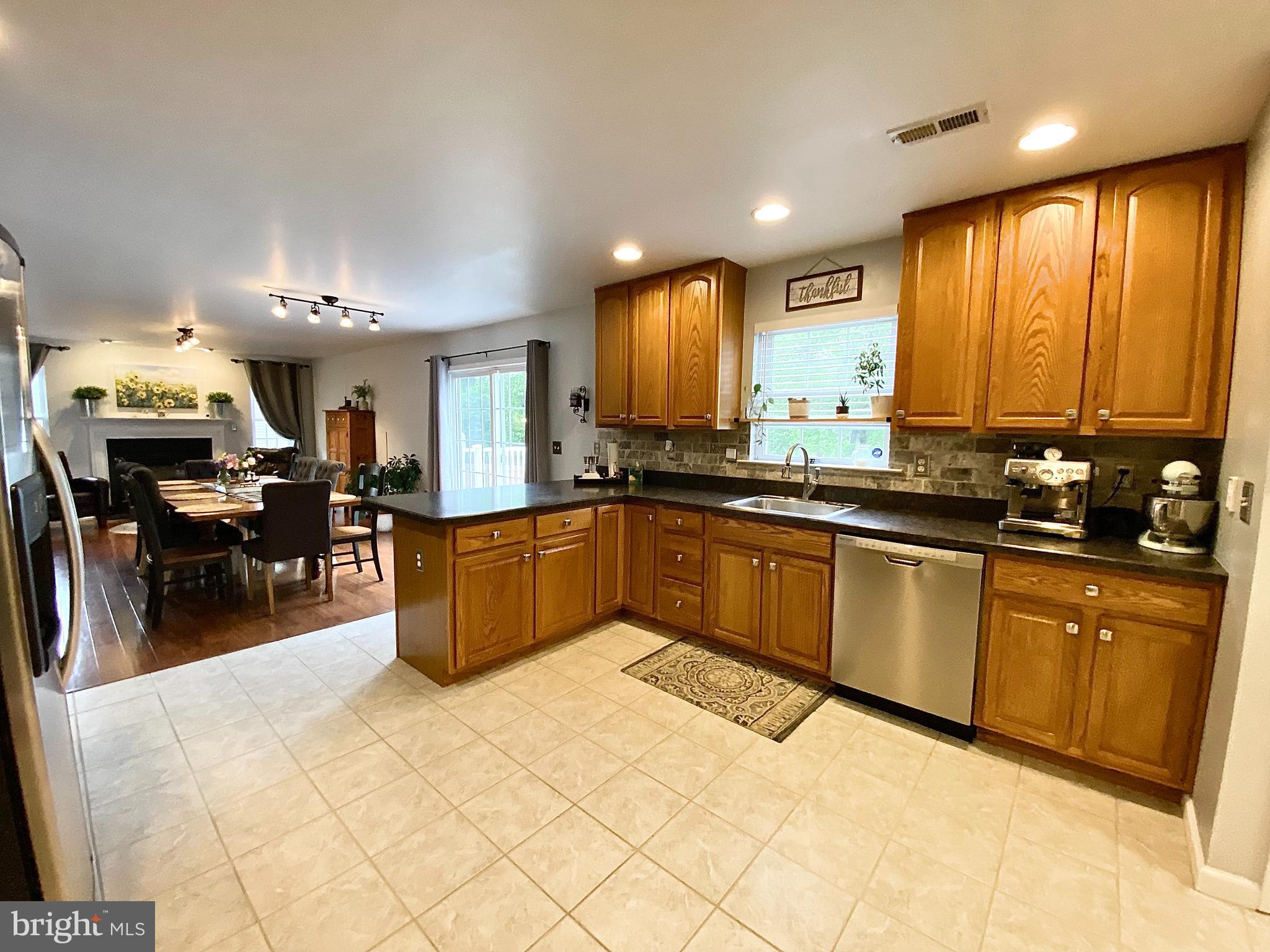 8 Augusta Street Wrightstown, NJ 08562 - Photo 12 of 44 a kitchen with stainless steel appliances granite countertop a sink counter space cabinets and a large window