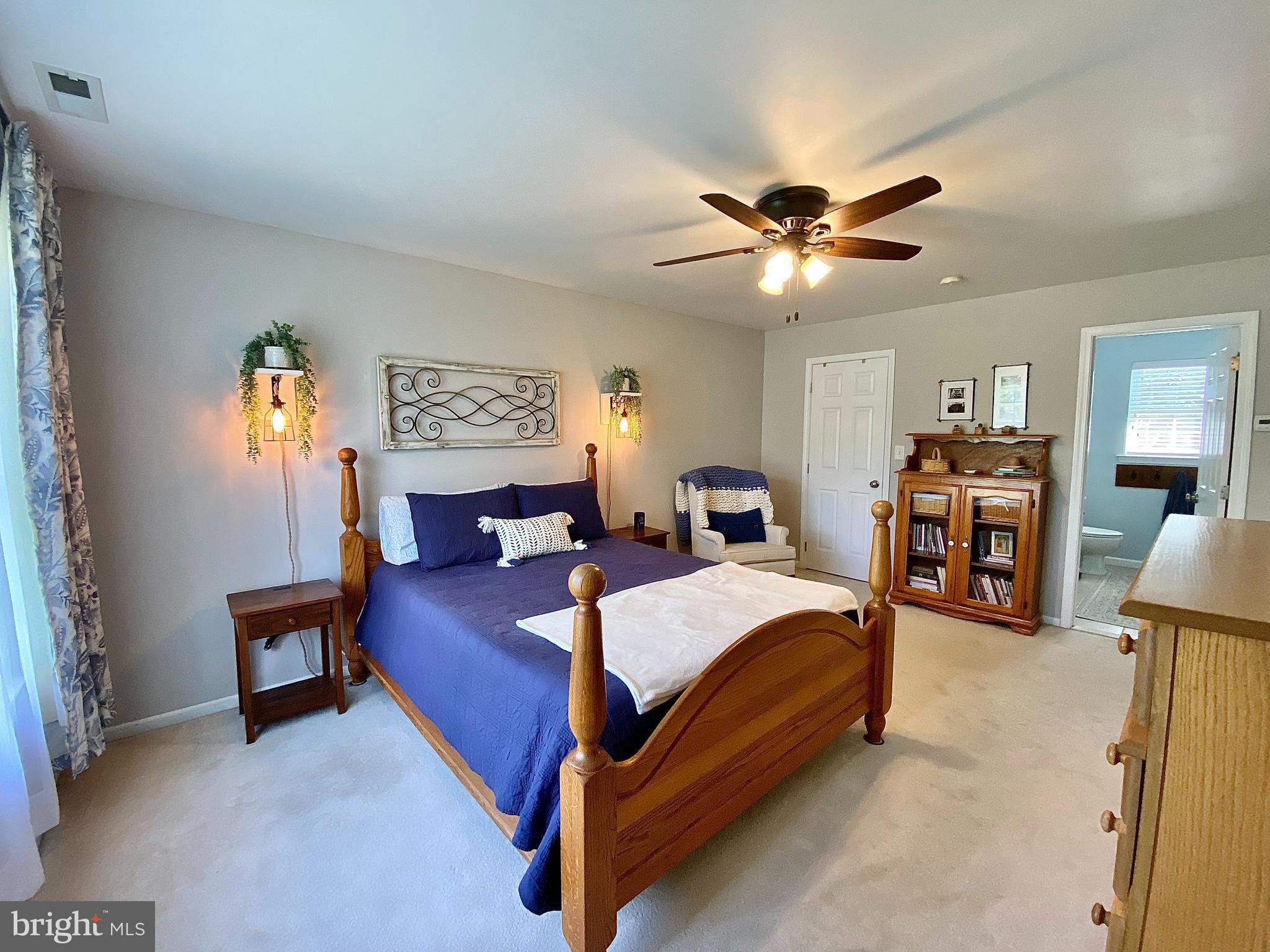 8 Augusta Street Wrightstown, NJ 08562 - Photo 16 of 44 a bedroom with a bed and a chandelier