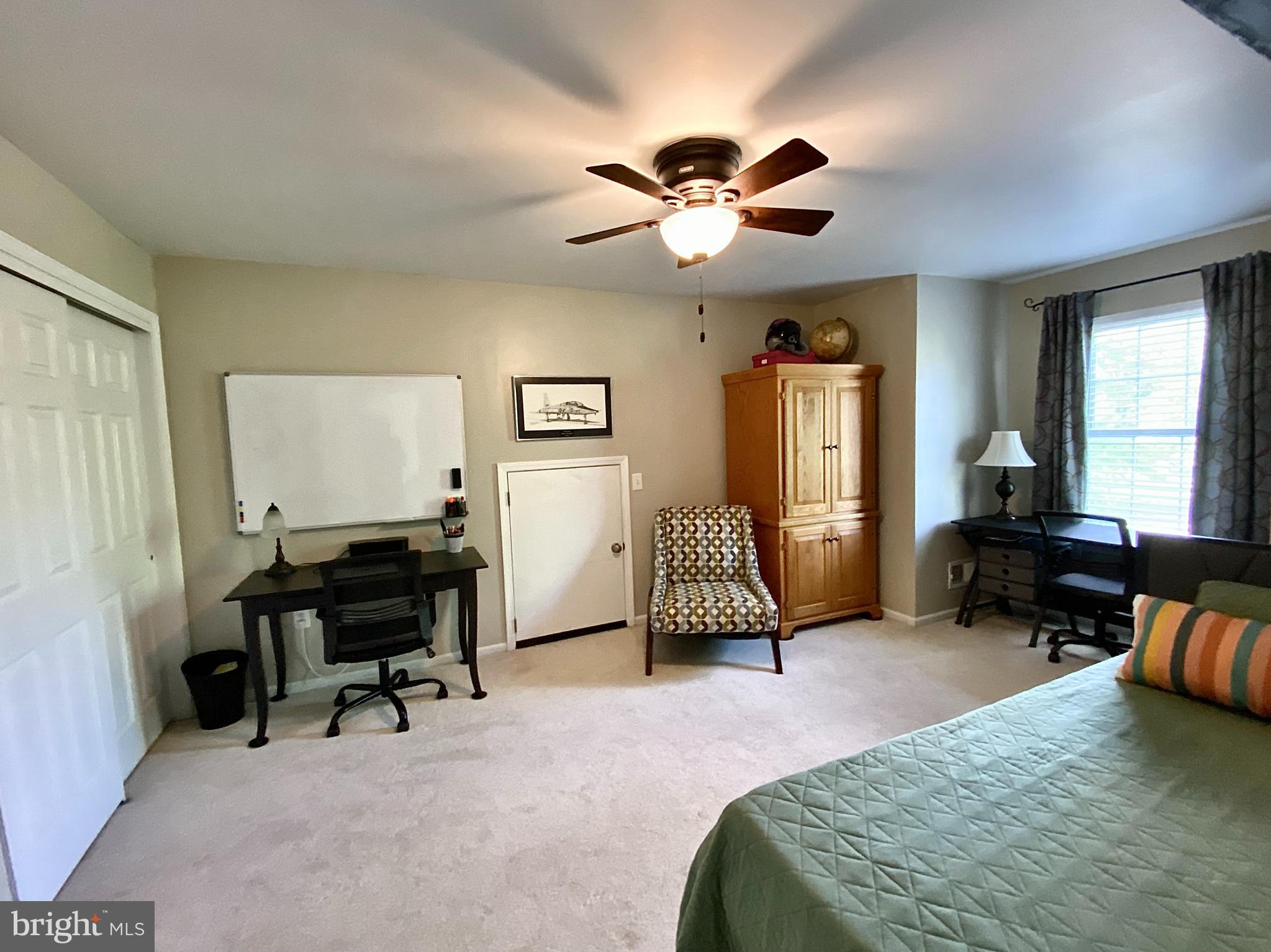 8 Augusta Street Wrightstown, NJ 08562 - Photo 22 of 44 a bedroom with a bed and a chandelier